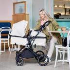 picture of a mum with Ickle Bubba Atom Travel System in a cafe