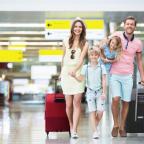 Happy family with suitcases in the airport
