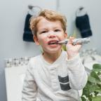picture of a toddler brushing his teeth with Dr Browns otter toothbrush
