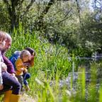 picture of a family exploring wetlands on a fun day out
