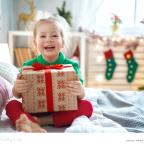 a happy child receiving a christmas present picture of a happy child receiving a christmas present