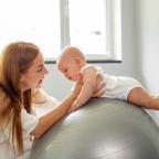 picture of a baby having tummy time on a blow up exercise ball