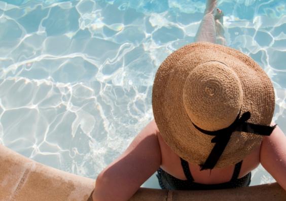 a woman sitting in a pool on holiday whilst solo travelling picture of a woman sitting in a pool on holiday whilst solo travelling
