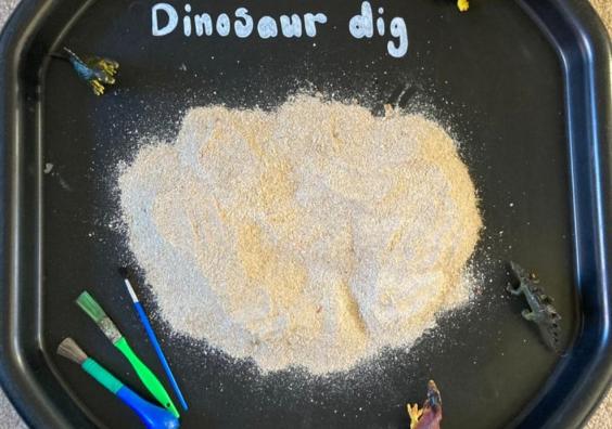 picture of dinosaur dig tuff tray activity for kids