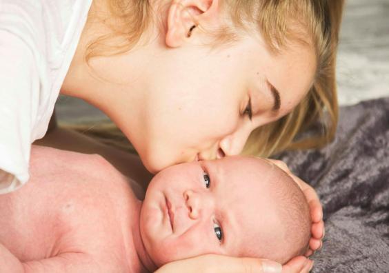 woman kissing baby