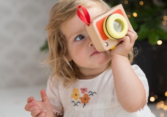 picture of a child playing with a My First Camera wooden toy