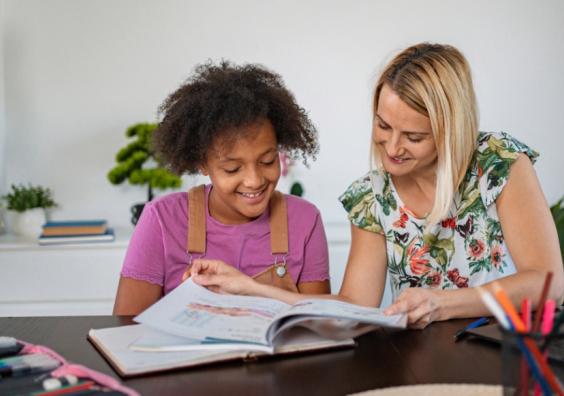picture of a happy child having tutoring support at home to boost confidence and help with exams