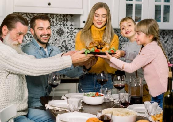 picture of a happy family having sunday lunch as part of a family tradition