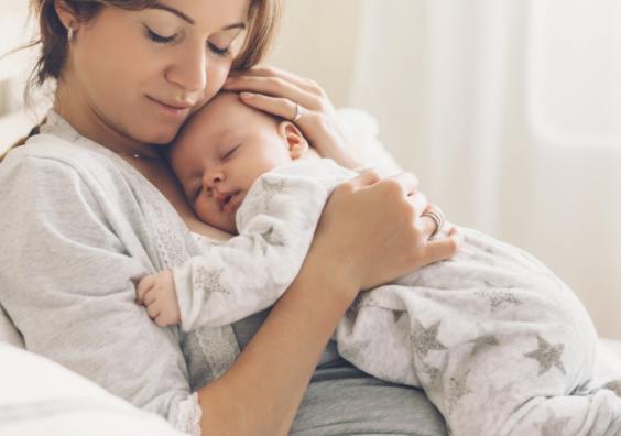 picture of a new mum with her sleeping new baby laying on her chest