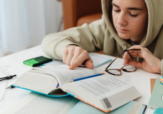 picture of a teenager revising for exams