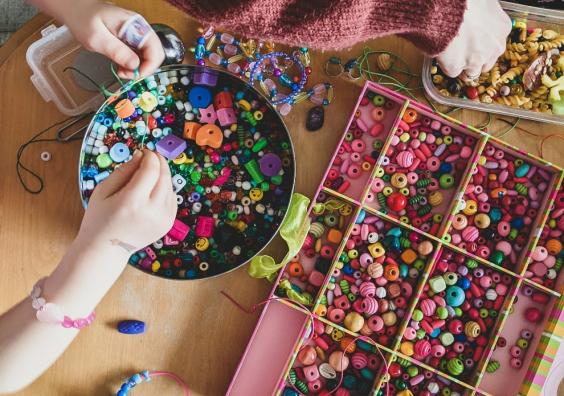 children making crafts with beads