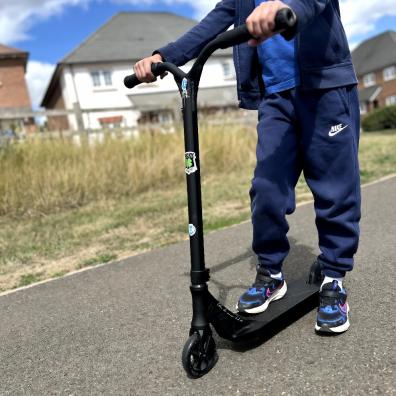 picture of a child riding a Ethic DTC Erawan V2 Complete Stunt Scooter