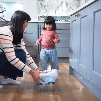 picture of a toddler in a kitchen ready to use a potette portable potty for toilet training