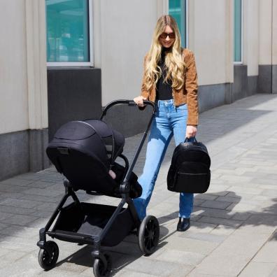 picture of a mum using the Altima Black 9 piece pushchair set