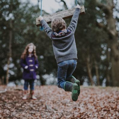 picture of children playing outside on a swing
