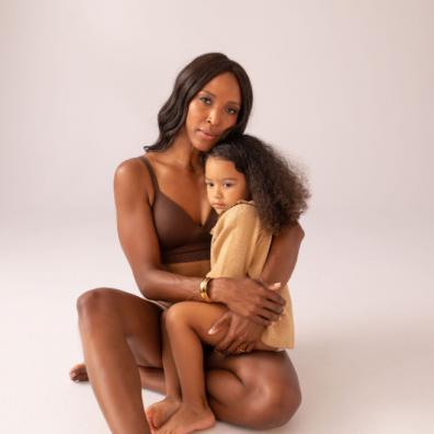 picture of woman wearing a post nursing bra with a child on her lap