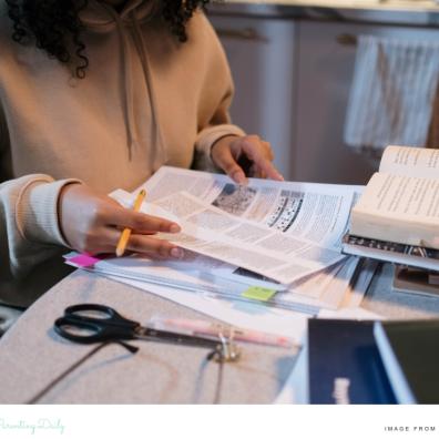 picture of a child revising at home for exams in a calm way with resources on the table