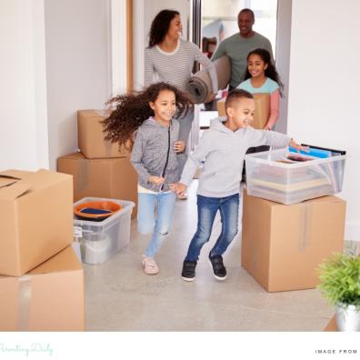 picture of a family moving into a new house with packing boxes around them