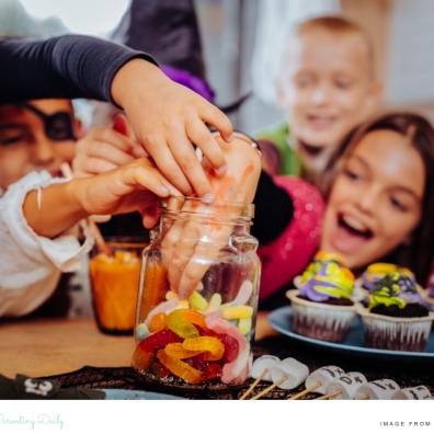 picture of a happy family digging into a sweet jar at Halloween