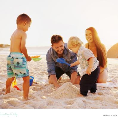 picture of a happy family on a beach building a sandcastle whilst on holiday