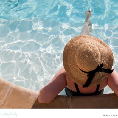 picture of a woman sitting in a pool on holiday whilst solo travelling