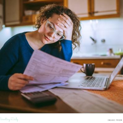 picture of a mum trying to juggle the cost of rising childcare bills