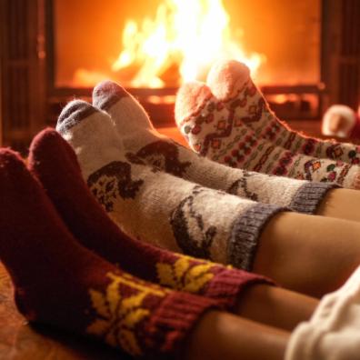 picture of people wearing socks in front of a real fire