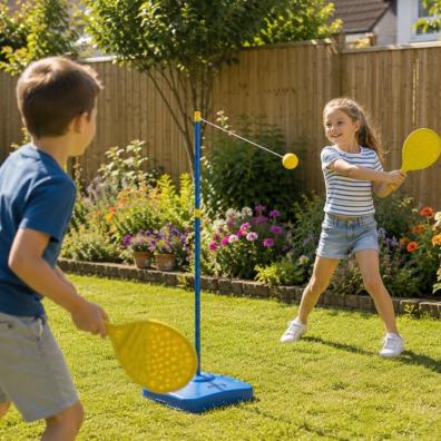 picture of Two happy children playing Swingball in a secure family garden with colourful flower beds and wooden fencing