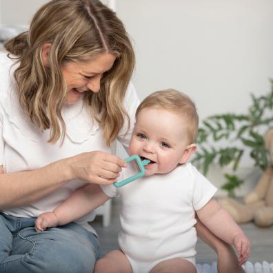 picture of a mum and baby with a cheeky chompers flexi brush