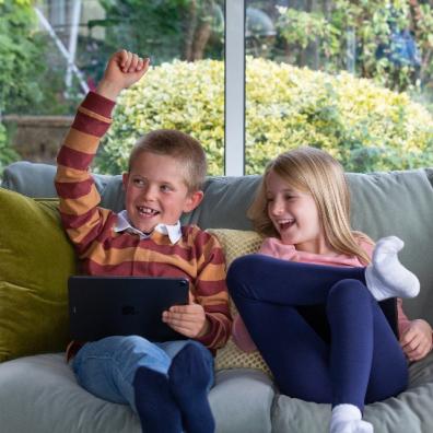 two happy children using the doodle maths app on devices picture of two happy children using the doodle maths app on devices