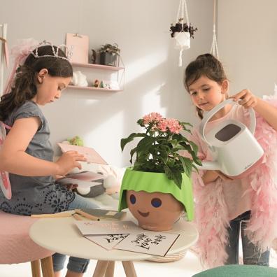 picture of children looking after houseplants