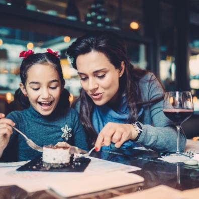 picture of a Mother and daughter eating in a restaurant