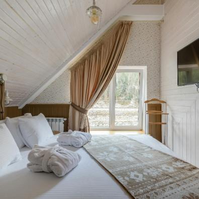 picture of a guest bedroom with a double bed and tv