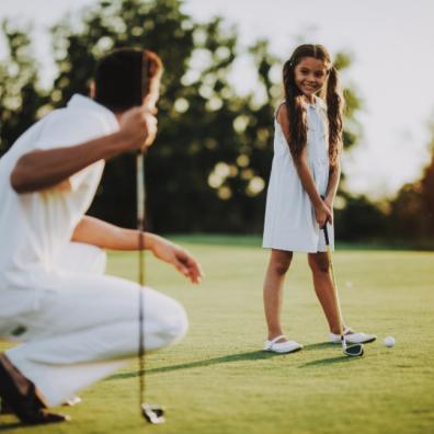Picture of a father and daughter playing golf