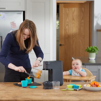 picture of mum using the Tommy Tippee Quick-Cook Baby Food Maker