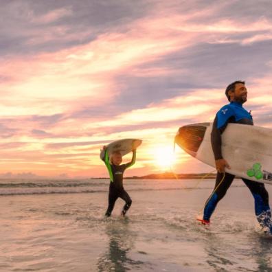 picture of father and son surfing in Guernsey
