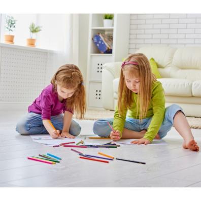 Picture of two children sitting on the floor doing some drawing