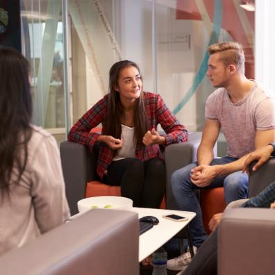 Picture of a group of university students sat around having a discussion