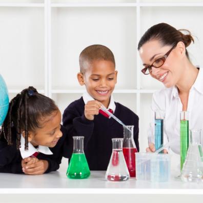 Picture of a science teacher doing experiments with primary school children