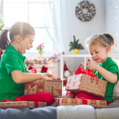 picture of excited children opening their christmas presents