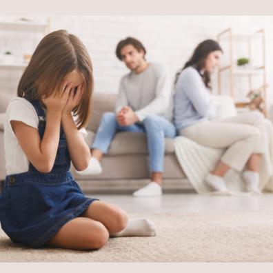 picture of upset child sat in front of arguing parents