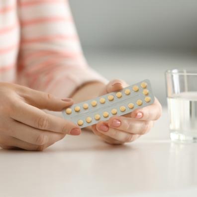 picture of woman holding a packet of contraceptive pills