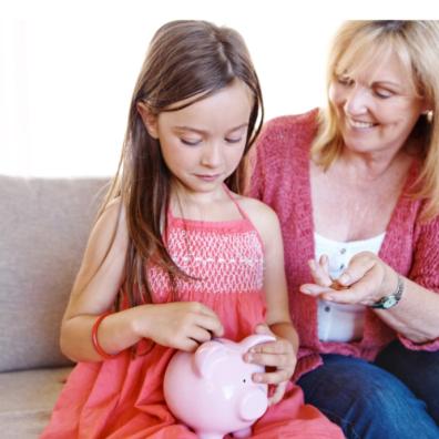 picture of a happy mum giving her daughter pocket money to put in a piggy bank
