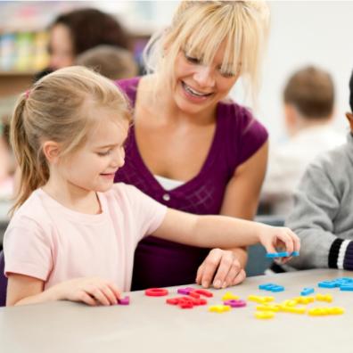picture of childcare worker and children in a daycare setting 