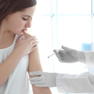 picture of a teenage girl getting a vaccination
