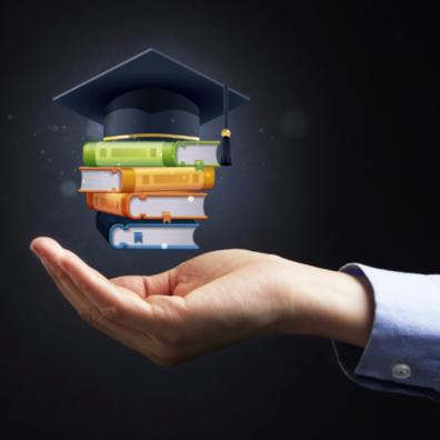 picture of hand holding school books and cap