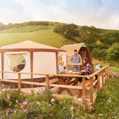 picture of a family having lunch at a glamping site