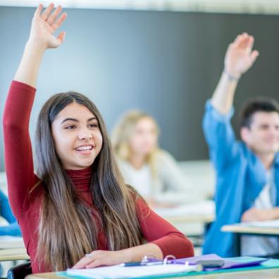 picture of smart students with their hands up 