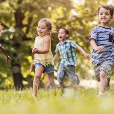 Picture of happy children running outside in the sun