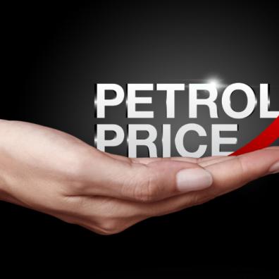 picture of a hand holding the words petrol price and a red arrow pointing up